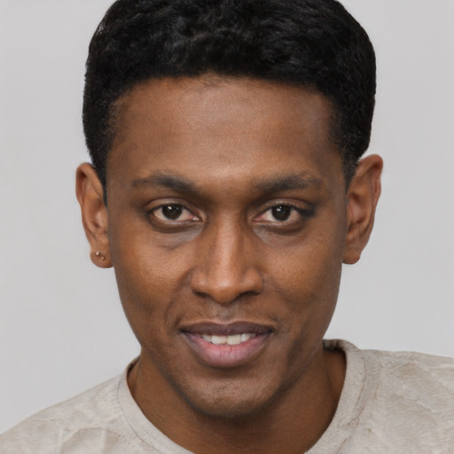 Joyful black young-adult male with short  black hair and brown eyes