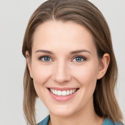 Joyful white young-adult female with medium  brown hair and grey eyes