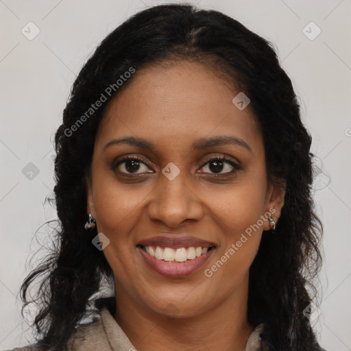 Joyful black young-adult female with long  brown hair and brown eyes