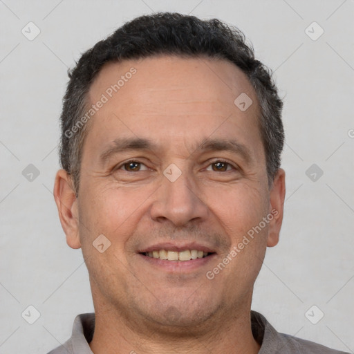 Joyful white adult male with short  brown hair and brown eyes