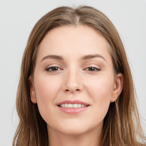 Joyful white young-adult female with long  brown hair and grey eyes