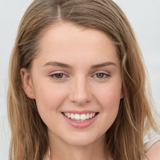 Joyful white young-adult female with long  brown hair and green eyes