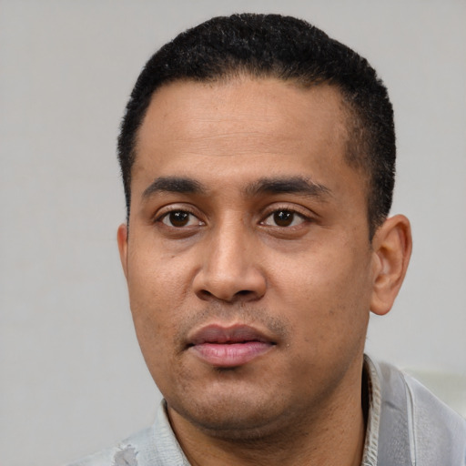 Neutral latino young-adult male with short  black hair and brown eyes