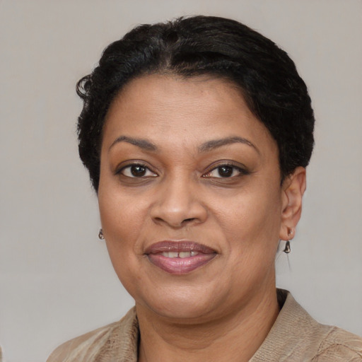 Joyful black adult female with short  brown hair and brown eyes