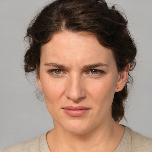 Joyful white young-adult female with medium  brown hair and green eyes