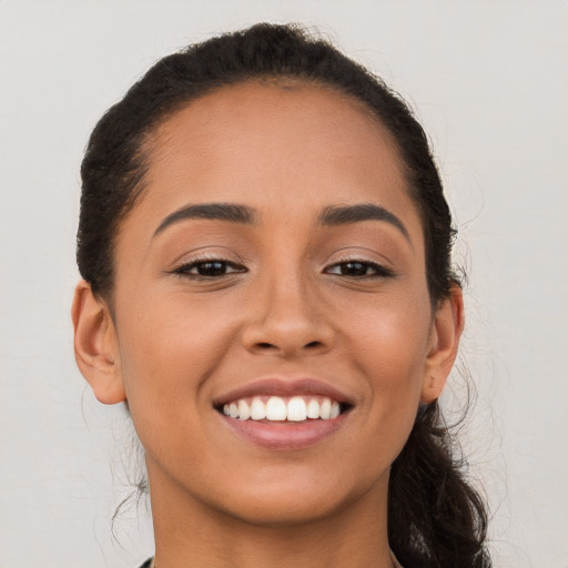 Joyful white young-adult female with long  brown hair and brown eyes