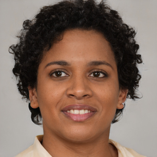 Joyful latino young-adult female with short  brown hair and brown eyes