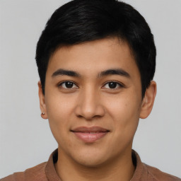 Joyful asian young-adult male with short  black hair and brown eyes