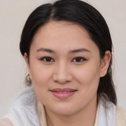 Joyful asian young-adult female with medium  brown hair and brown eyes