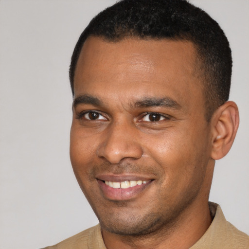 Joyful latino young-adult male with short  brown hair and brown eyes