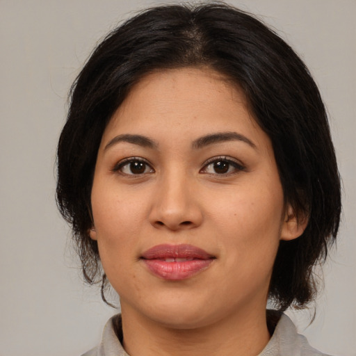 Joyful asian young-adult female with medium  brown hair and brown eyes