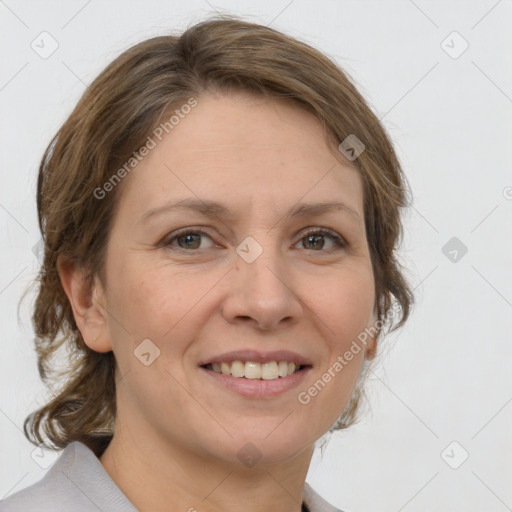 Joyful white adult female with medium  brown hair and grey eyes