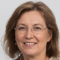 Joyful white middle-aged female with medium  brown hair and grey eyes