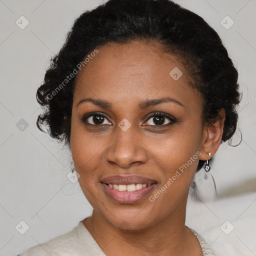 Joyful black adult female with medium  brown hair and brown eyes