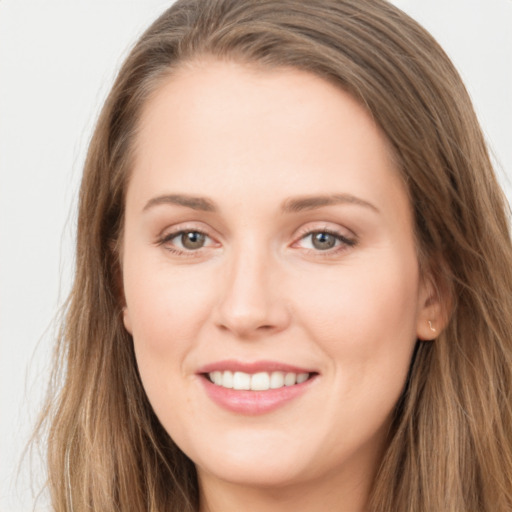 Joyful white young-adult female with long  brown hair and grey eyes