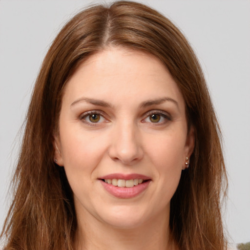 Joyful white young-adult female with long  brown hair and green eyes