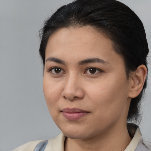 Joyful latino young-adult female with medium  brown hair and brown eyes