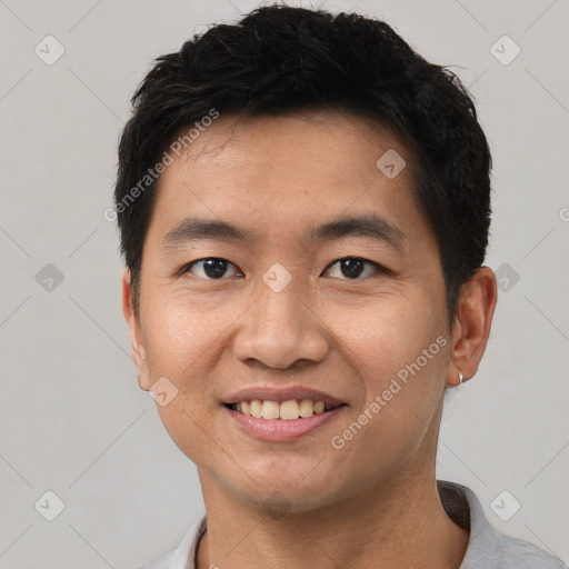 Joyful asian young-adult male with short  black hair and brown eyes