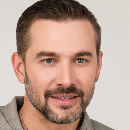 Joyful white young-adult male with short  brown hair and brown eyes