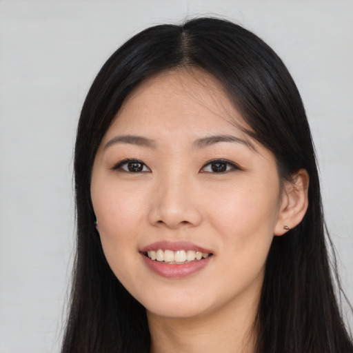 Joyful asian young-adult female with long  black hair and brown eyes