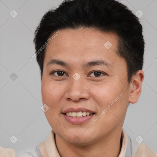 Joyful latino young-adult male with short  brown hair and brown eyes