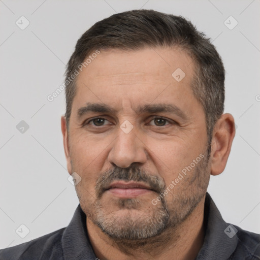 Joyful white adult male with short  black hair and brown eyes