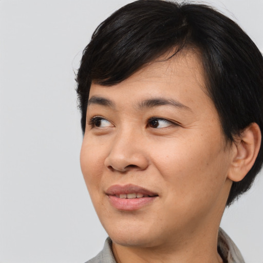 Joyful asian young-adult female with medium  black hair and brown eyes