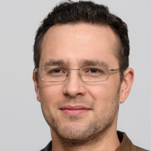 Joyful white adult male with short  brown hair and grey eyes