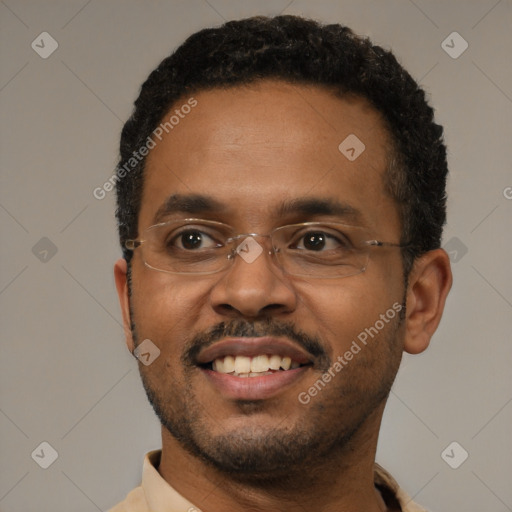Joyful black young-adult male with short  black hair and brown eyes
