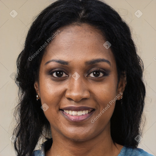 Joyful black young-adult female with long  black hair and brown eyes