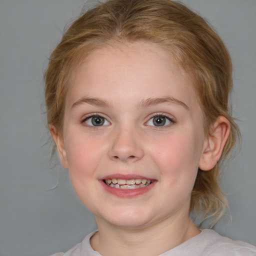 Joyful white child female with medium  brown hair and blue eyes