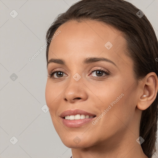 Joyful white young-adult female with long  brown hair and brown eyes