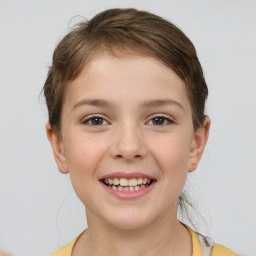 Joyful white child female with medium  brown hair and brown eyes