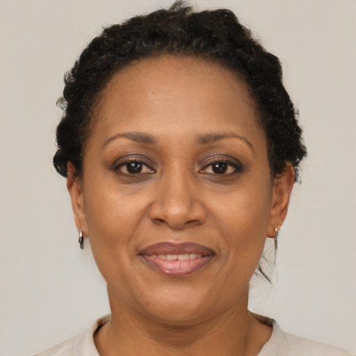 Joyful latino adult female with short  brown hair and brown eyes