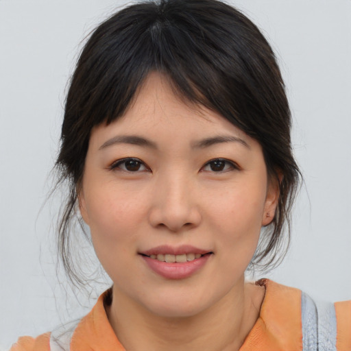 Joyful asian young-adult female with medium  brown hair and brown eyes