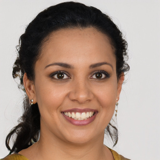 Joyful latino young-adult female with medium  brown hair and brown eyes