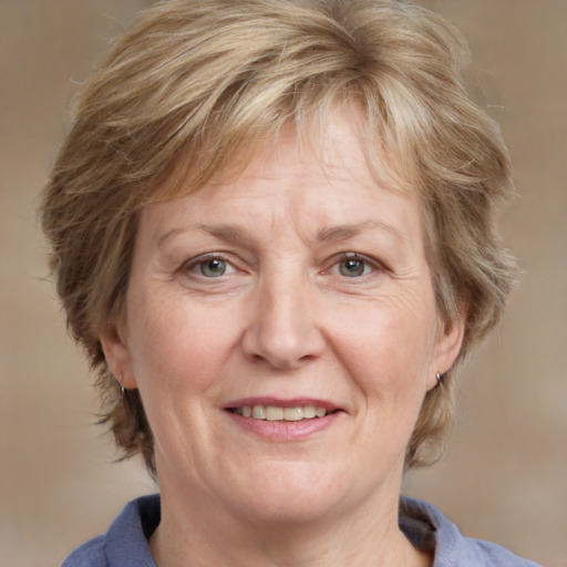 Joyful white middle-aged female with medium  brown hair and blue eyes