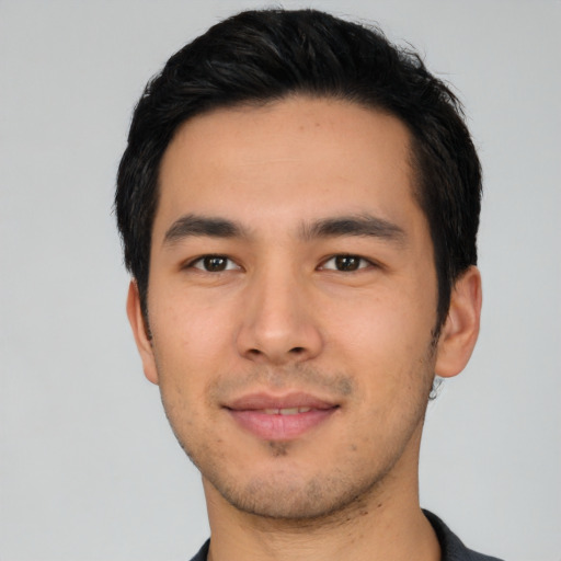 Joyful asian young-adult male with short  black hair and brown eyes
