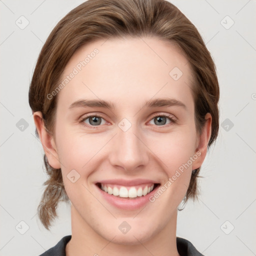 Joyful white young-adult female with medium  brown hair and grey eyes