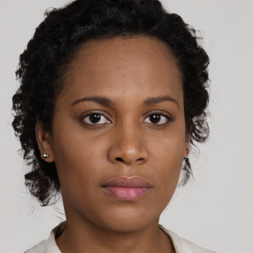 Neutral black young-adult female with medium  brown hair and brown eyes