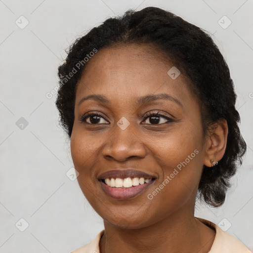 Joyful black young-adult female with medium  brown hair and brown eyes