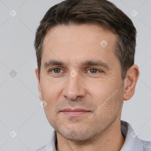 Joyful white adult male with short  brown hair and brown eyes