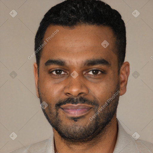 Joyful black young-adult male with short  black hair and brown eyes