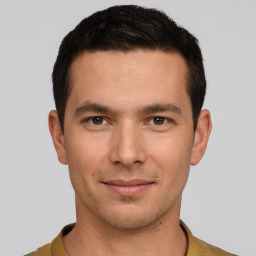 Joyful white young-adult male with short  brown hair and grey eyes