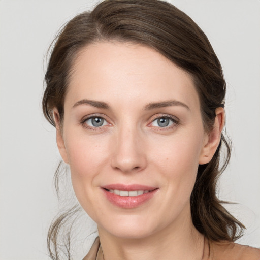 Joyful white young-adult female with long  brown hair and grey eyes