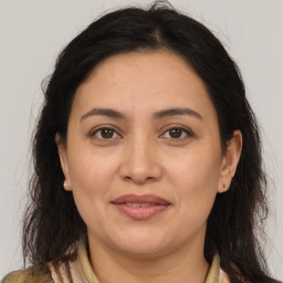 Joyful white adult female with long  brown hair and brown eyes