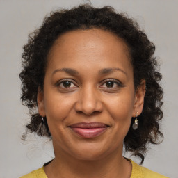 Joyful black adult female with medium  brown hair and brown eyes