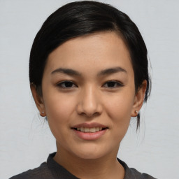 Joyful asian young-adult female with medium  black hair and brown eyes