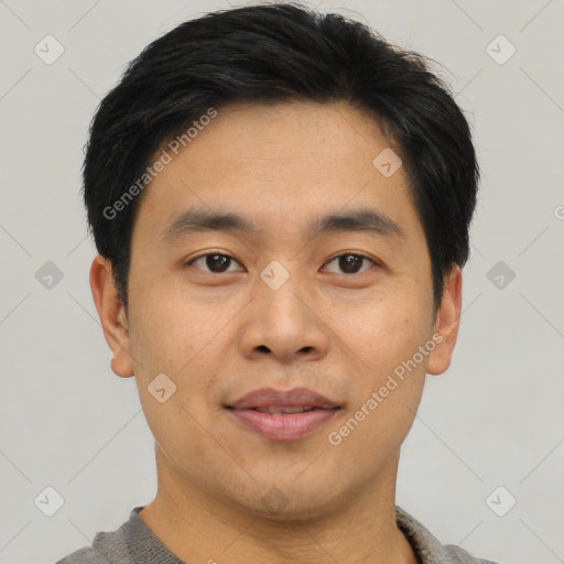 Joyful asian young-adult male with short  black hair and brown eyes