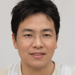 Joyful asian young-adult male with short  brown hair and brown eyes